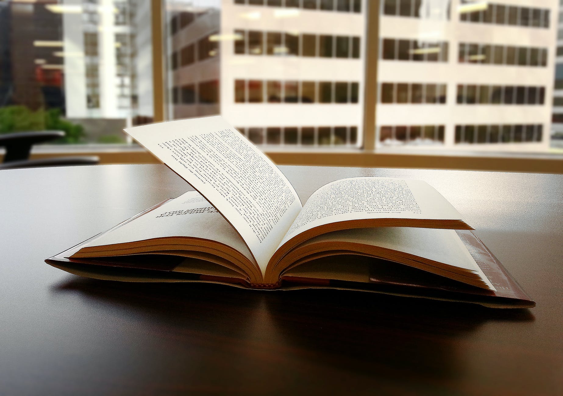 opened book on top of table